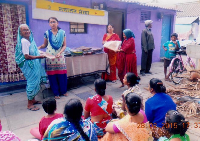 Distributing saris to needy women